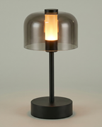 Flame Bell smoked-glass bell lamp, LED flame 2000K, touch, USB-C cordless — lit hero shot | Dalfa CH/FR