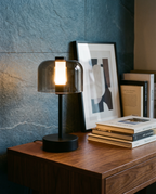 Flame Bell smoked-glass bell lamp, LED flame 2000K, touch, USB-C cordless — in an evening corner | Dalfa CH/FR