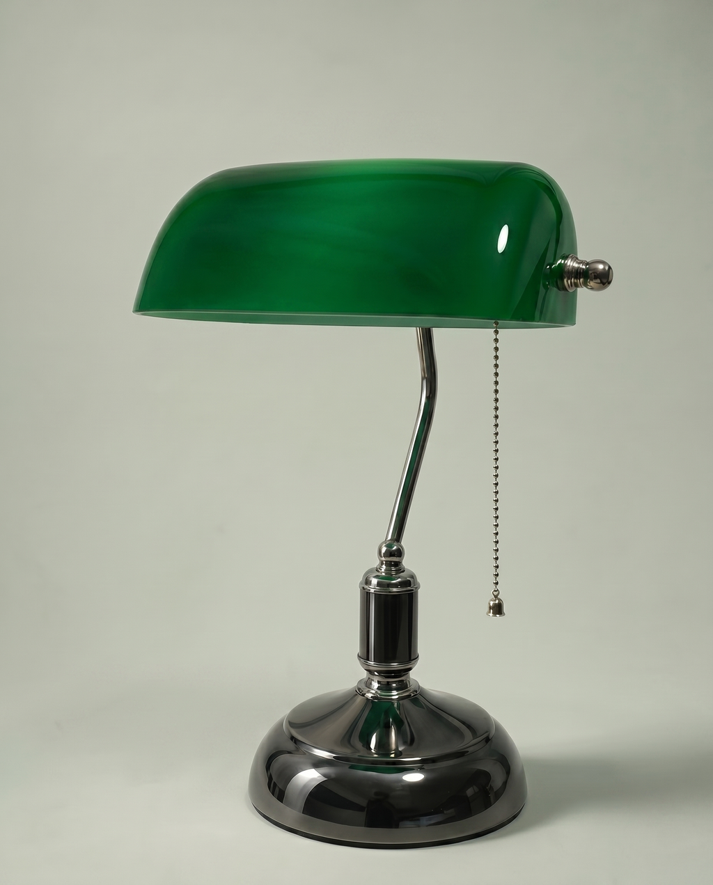 Green Banker desk lamp, emerald green glass shade, brass arm, dark chrome base — off, studio shot | Dalfa CH/FR