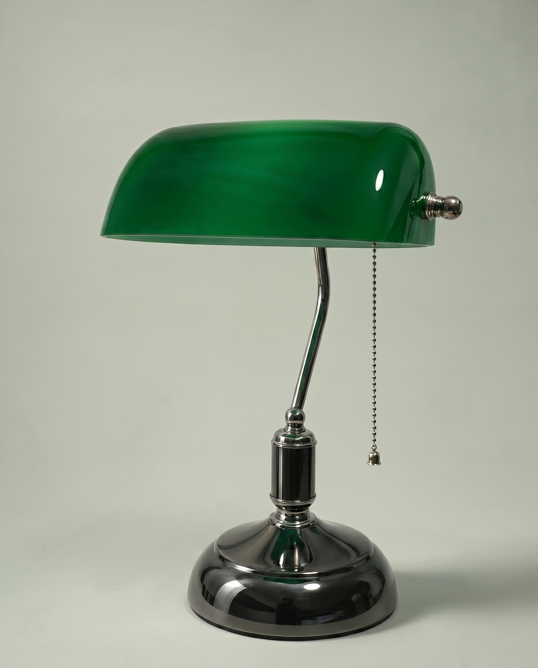 Green Banker desk lamp, emerald green glass shade, brass arm, dark chrome base — off, studio shot | Dalfa CH/FR