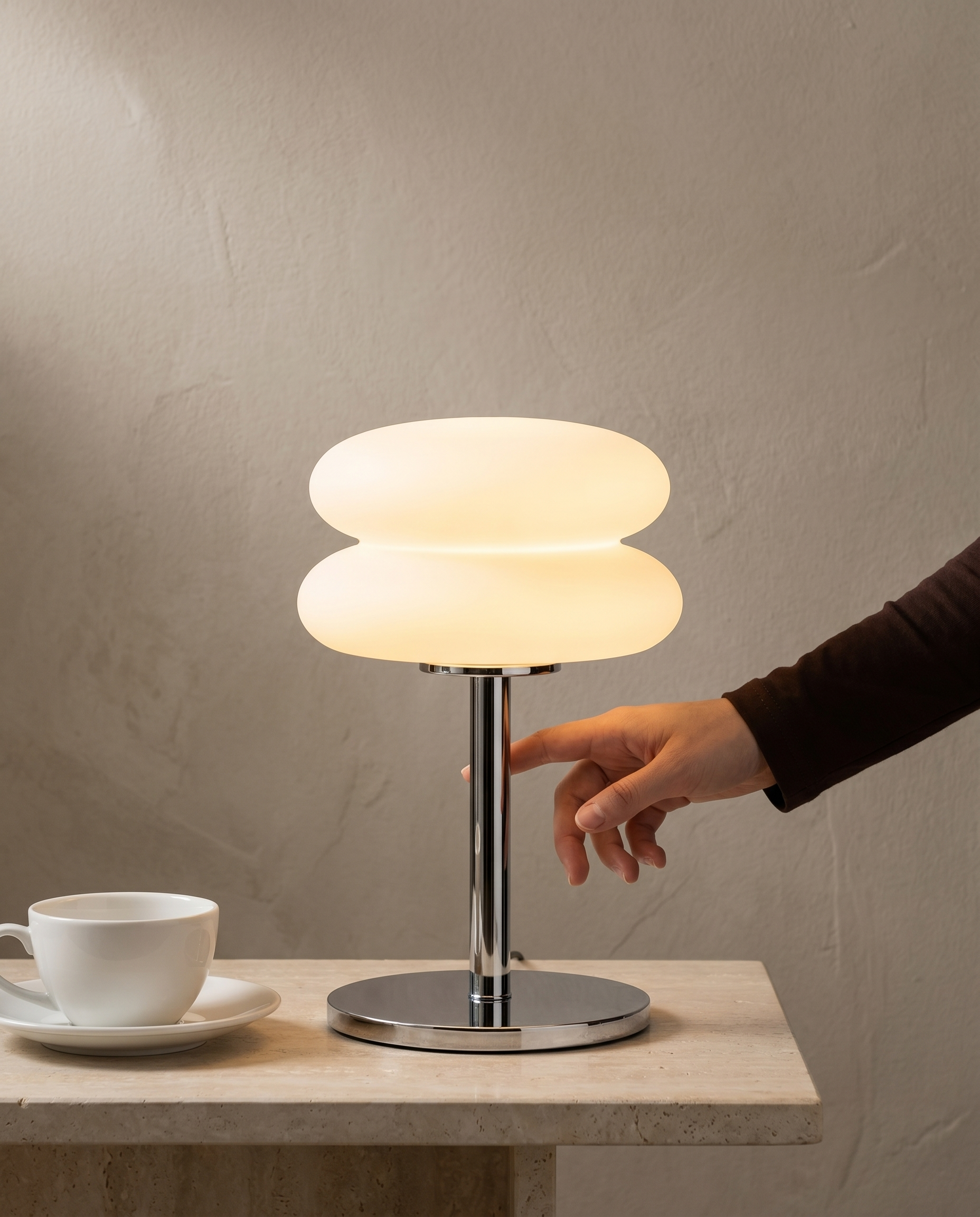 Double Disk chrome lamp, twin silicone disks, 3 colour temperatures, 29.5 cm — in use, fingertip on the chrome stem | Dalfa CH/FR