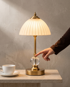 Ribbed Crystal brass lamp, frosted ribbed glass shade, cut crystal stem, 31.5 cm — in use, fingertip on the crystal sphere | Dalfa CH/FR
