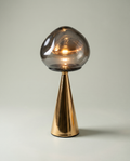 Mushroom Fumé smoked blown-glass globe lamp, golden cone base, dimmer 2700K — lit hero shot | Dalfa CH/FR